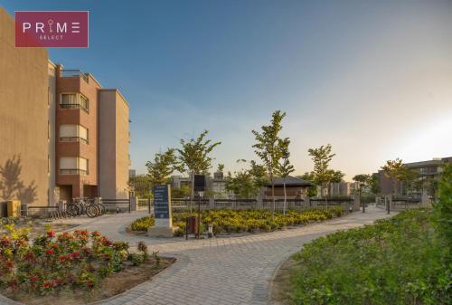 a brick walk way with flowers in a park at Prime Select New Giza in Giza