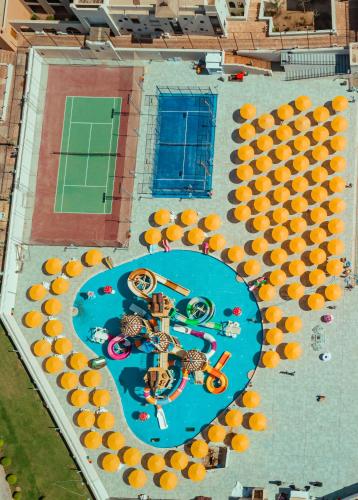 an overhead view of a swimming pool with orange umbrellas at Pickalbatros The Palace Port Ghalib in Port Ghalib