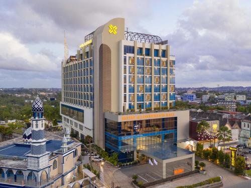 a large building with a clock on top of it at Platinum Hotel & Convention Hall Balikpapan in Balikpapan