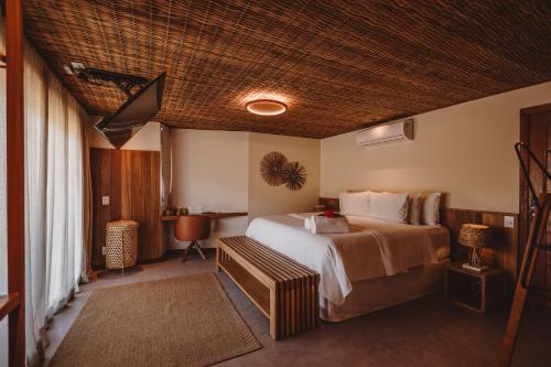 a hotel room with a large bed and a television at Pousada Moana in Fernando de Noronha