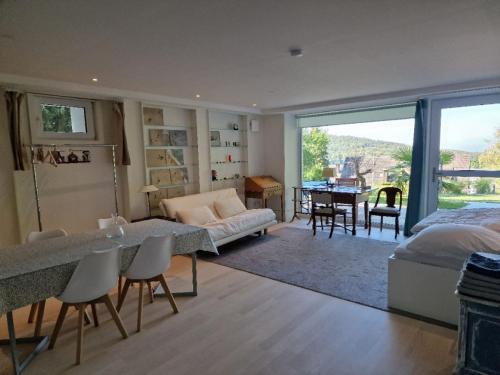 a bedroom with a bed and a living room with a table at Bellavista in Badenweiler