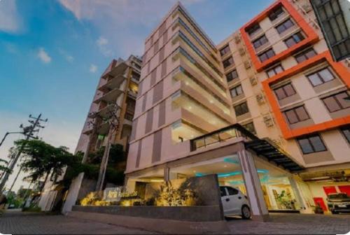 a building with a car parked in front of it at Yukari Seturan Yogyakarta at Altuz Apartment in Seturan