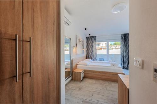 a bedroom with two beds and a window at Aparthotel Plat in Kožino