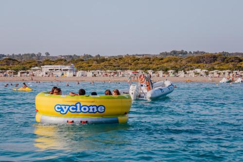 a group of people riding in an inflatable raft in the water at Blue And Blue City in Ugento