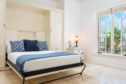 a bedroom with a bed and a window at Villa with Sea View in Providenciales