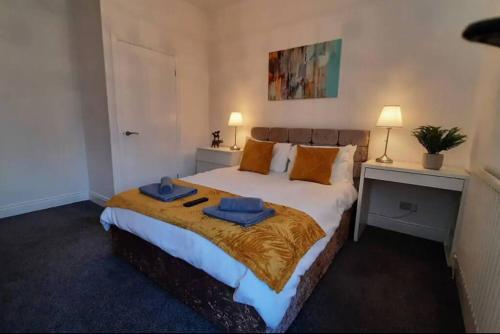 a bedroom with a large bed with two towels on it at Finsbury Workstays UK in Middlesbrough