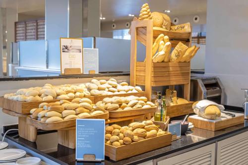 a bakery with lots of baskets of bread and pastries at Barceló Costa Ballena Golf & Spa in Costa Ballena