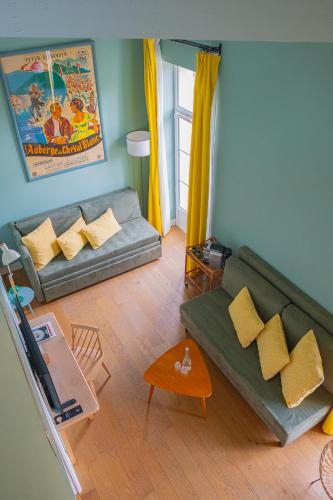a living room with a couch and a table at Hôtel Le Saint Christophe in La Baule