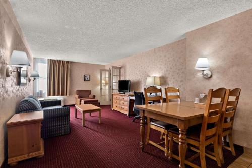 a hotel room with a table and a living room at Quality Inn & Suites in Craig