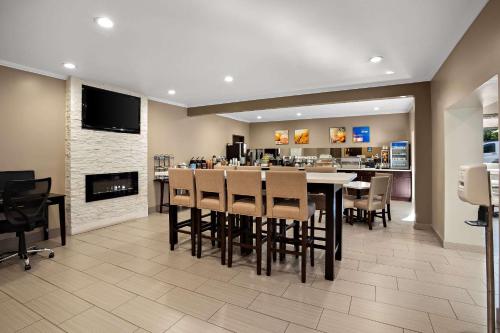 a restaurant with a table and chairs and a fireplace at Comfort Inn Lacey - Olympia in Lacey