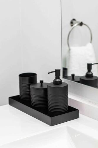 a pile of plates on a shelf in front of a mirror at Epic Getaway in Waterfall in Midrand