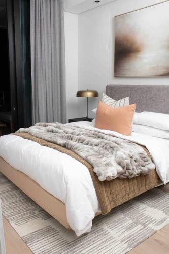 a bedroom with a large bed with a blanket at Epic Getaway in Waterfall in Midrand