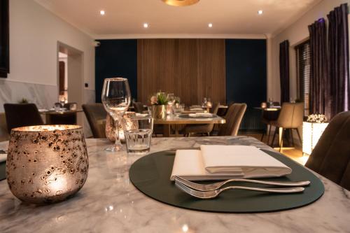 a dining room with a table with a plate of food at Asperion Hillside Hotel in Guildford
