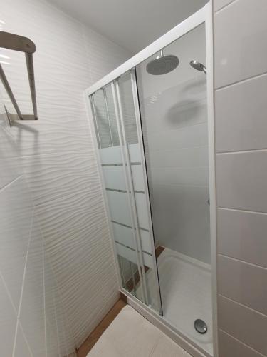 a shower with a glass door in a bathroom at Zabava Sacavém in Sacavém