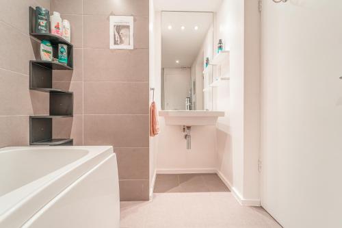 a bathroom with a sink and a bath tub at Modern flat in PRIME LOCATION near Shoreditch & Brick lane in London