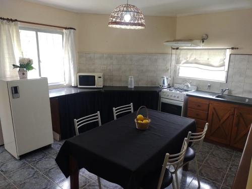 a kitchen with a table with a bowl of fruit on it at DEPARTAMENTO UMARDA in Tandil