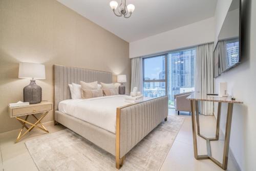 a bedroom with a large bed and a large window at Central Park Towers, City View - DIFC - Mint Stay in Dubai