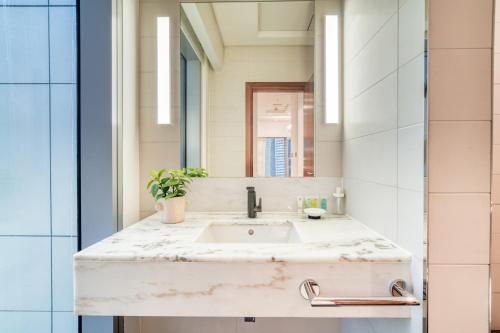 a bathroom with a sink and a mirror at Central Park Towers, City View - DIFC - Mint Stay in Dubai