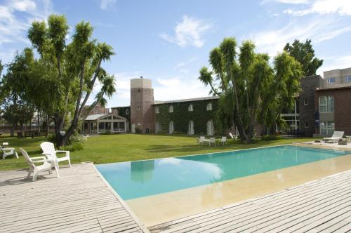 a swimming pool in the backyard of a house at La Posada De Madryn in Puerto Madryn