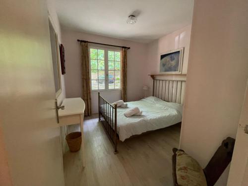 a small bedroom with a bed and a window at Le Pre du Moulin in Courniou
