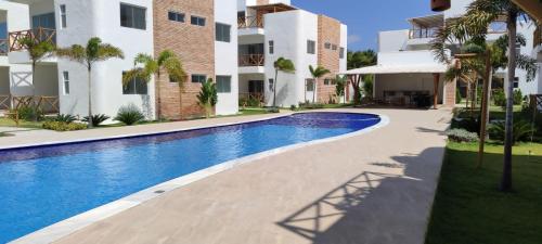a swimming pool in front of a apartment building at Vila do Mar - Macapá in Luis Correia