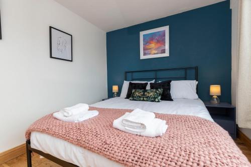 a bedroom with a bed with towels on it at Seaside Haven for all the family in Marske-by-the-Sea
