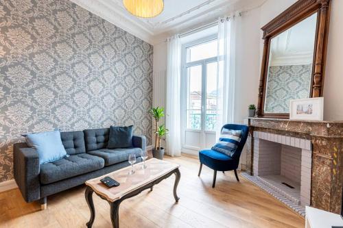 a living room with a couch and a fireplace at Secteur Gare et GEM: 2 pièces - fibre - confort + in Grenoble