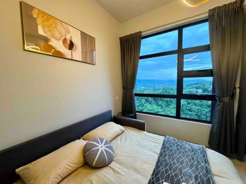 a bedroom with a bed with a large window at CC Suites Jesselton Quay - Seaview - 2Bedroom in Kota Kinabalu
