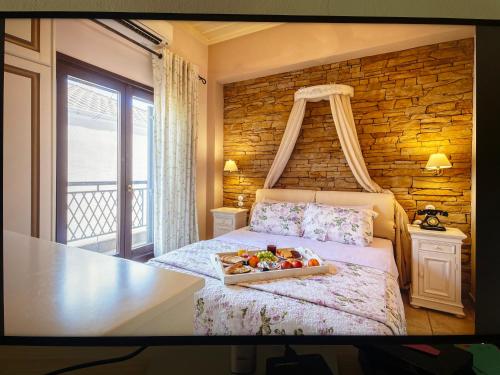 a bedroom with a bed with a tray of fruit on it at Giogarakis Suites in Eleonas