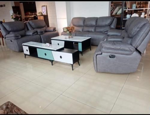 a living room with two couches and a coffee table at The place rich in Nairobi