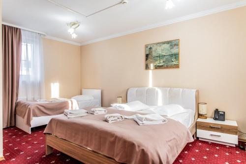 a hotel room with two beds and a window at Star Rent Hotel in Chişinău