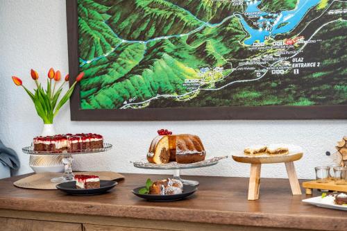 a table with cakes and pastries on top at B&B Villa Sumrak Plitvica in Plitvica selo