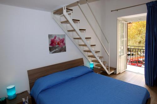 a bedroom with a blue bed and a staircase at B&B Teatro in Palermo