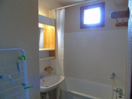 a bathroom with a sink and a toilet and a window at Appartement Valfréjus, 2 pièces, 6 personnes - FR-1-561-18 in Valfréjus