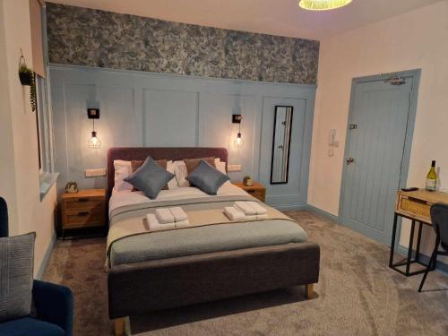 a bedroom with a large bed and a desk at The Coastal Hideaway in Bridlington
