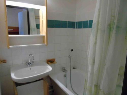 a bathroom with a sink and a shower and a tub at Appartement Valfréjus, 3 pièces, 6 personnes - FR-1-561-20 in Valfréjus