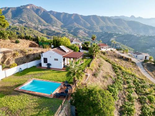 a house on a hill with a swimming pool at Vela Luka Frigiliana in Frigiliana