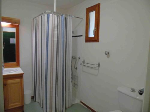 a bathroom with a shower curtain and a sink at Appartement Valfréjus, 2 pièces, 4 personnes - FR-1-561-32 in Valfréjus