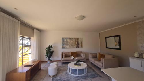 a living room with a couch and a table at 2 On Lismore Guesthouse in Tokai