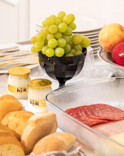 a table with a bowl of grapes and other foods at Ollu e Stentu in Dolianova