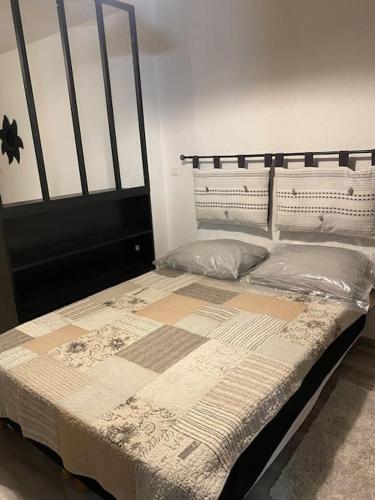 a bedroom with a large bed with a black frame at Studio AIX LES BAINS in Aix-les-Bains