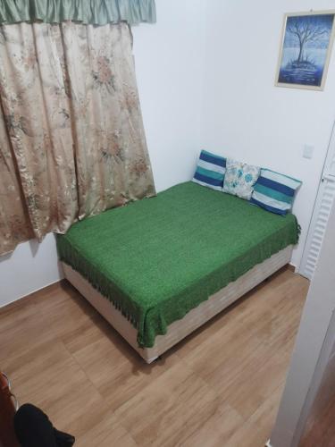 a small bed in a room with a window at Hostel Sancris in São José dos Campos
