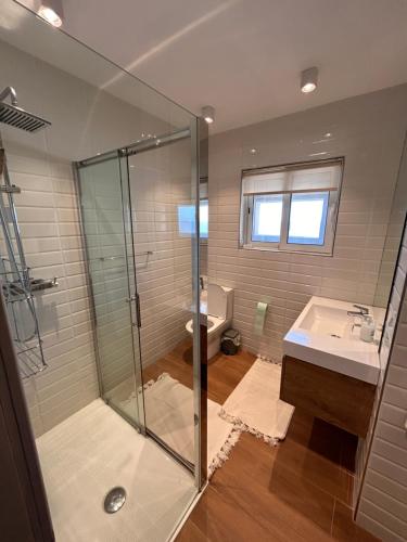 a bathroom with a shower and a sink and a toilet at Luxury Private Room - TV in Paceville