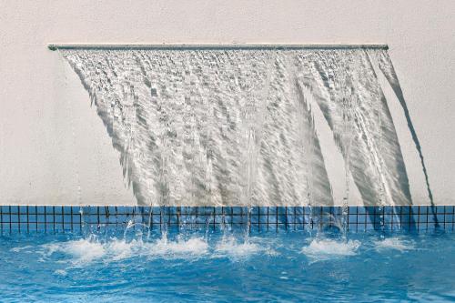 a shower with water coming out of it at Tropical Contemporary Suites in Paraty