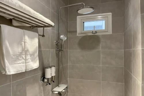 a bathroom with a shower and a window at Lanura Apartments and Hotel in Ho Chi Minh City