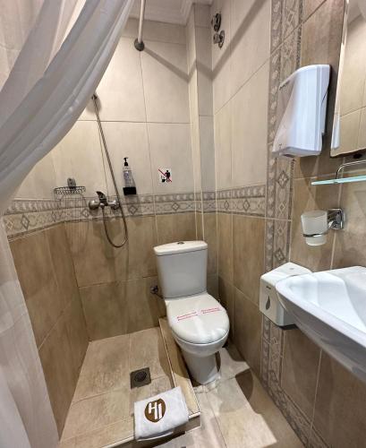 a bathroom with a toilet and a sink at Hotel Ilisia in Thessaloniki