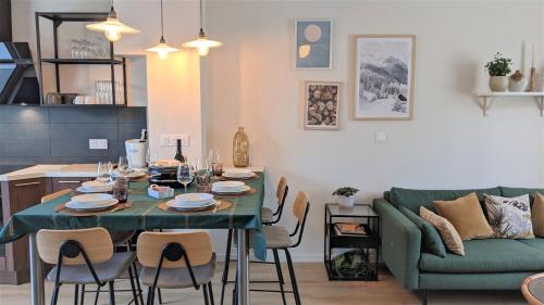 a living room with a table and a couch at LE CEMAROSE Cottage & Spa Terrace Garden & lovely View in Épernay
