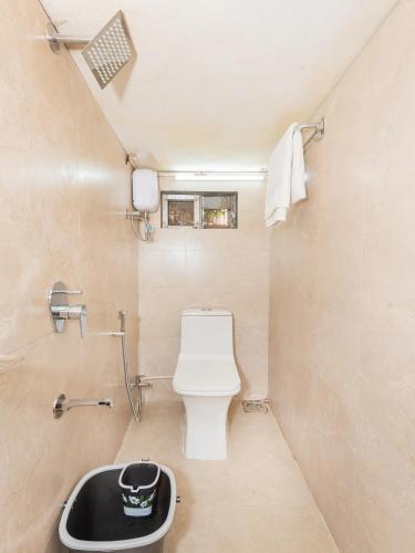 a small bathroom with a toilet and a sink at Hotel BKC Fortune in Mumbai
