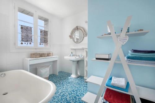 a bathroom with a white tub and a sink at Maison de maître Baie de la Baule-9 in Pornichet