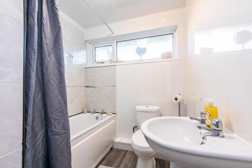 a bathroom with a sink and a toilet and a bath tub at Bodmin House - Charming 3-Bedroom Terrace House with Private Enclosed Garden in Wallsend